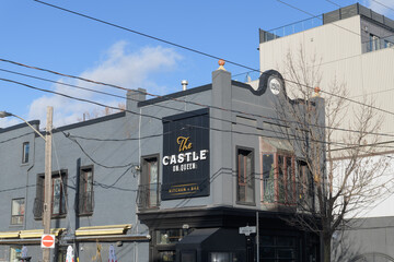Fototapeta premium exterior building and sign of The Castle On Queen, a restaurant, located at 884 Queen St E, Toronto