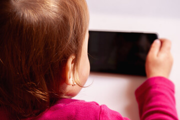 Girl enjoying technology and looking directly at the camera.