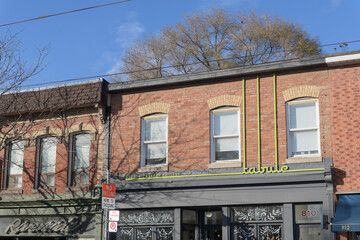 Obraz premium exterior building facade and sign of Tabule, a Middle Eastern restaurant, located at 810 Queen St E, Toronto