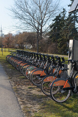 Fototapeta premium bike rental docking station with vehicles, Toronto - Lake Shore Blvd E near Leslie St
