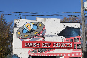 Fototapeta premium exterior building mural sign of Dave's Hot Chicken located here at 1130 Queen St E, Toronto