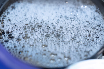 Closeup of soap bubbles in water
