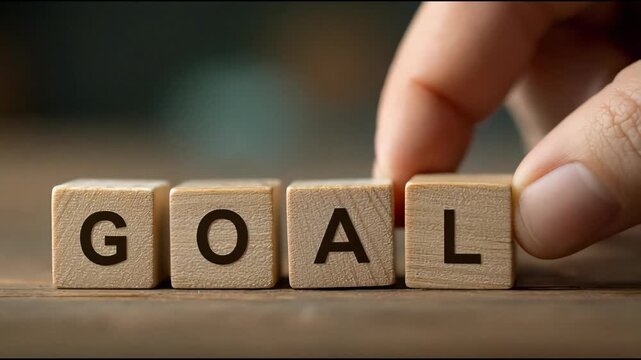 Wooden block with goal character on table for target motivation.
