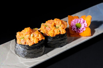 sushi on a black plate