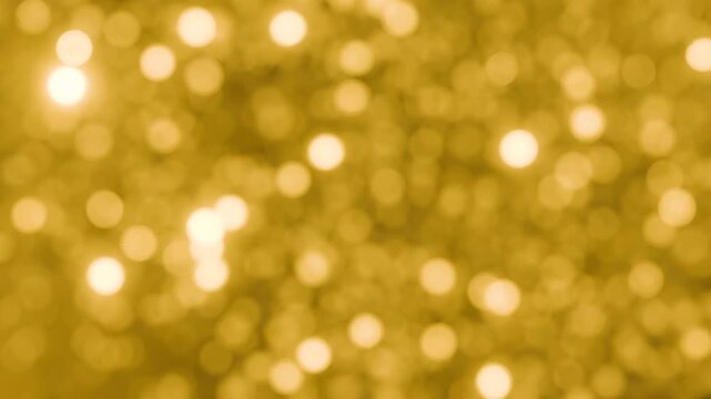 Glitter rain. Gold background with sparkling tinsel and bokeh effect, seamless loop. Festive background for winter holidays, Christmas, any  celebrations. 3D animation, motion graphic, 4k resolution