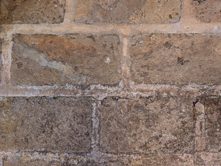 Close-up texture of worn distressed Mar&eacute;s stone slabs on rustic Mallorcan patio floor. Courtyards and patios traditional limestone surface, Mediterranean architecture. Weathering, cracking, age. 