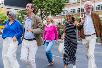 Fototapeta premium Group of senior friends walking happy on city street
