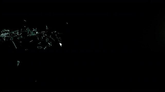 Super Slow Motion Shot of Real Side-Flying Glass Shards Isolated on Black at 1000 fps.