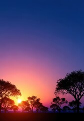 Fototapeta premium Silhouetted trees line the peaceful horizon during a stunning evening sunset. Capturing the tranquility and beauty of twilight colors approaching nightfall, panorama, golden hour, backlit