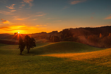 Naklejka premium Sunrise Over Rolling Hills in Suwalski Park Krajobrazowy, Poland.