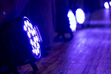 beams of stage lighting illuminate the stage of the hall before the performance