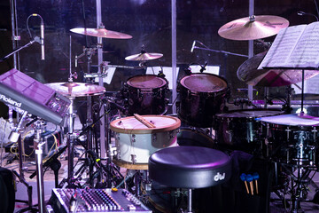 Drum kit on stage before a concert behind a screen