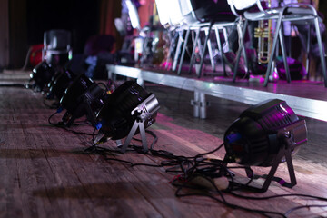 beams of stage lighting illuminate the stage of the hall before the performance