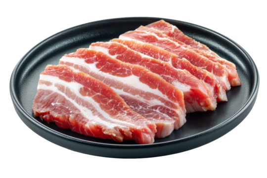 Raw sliced beef ribs in a dark bowl isolated on transparent background. Freshly sliced raw pork belly meat ready for cooking on a dark plate isolated on white background.