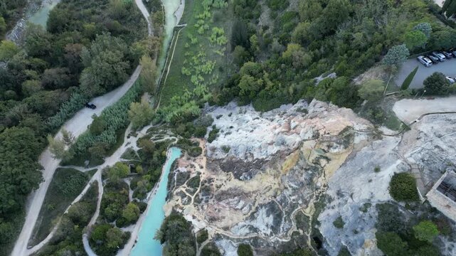 Aerial drone footage of the Antiche Terme Romane Libere, showcasing ancient Roman thermal ruins, natural pools, and the surrounding landscape. Captured from above with cinematic movement and clear arc