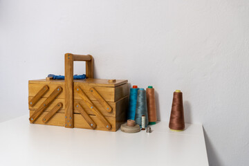 wooden box with spools of thread