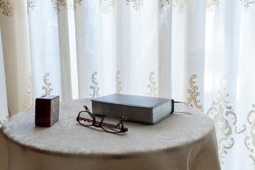 book and eyeglasses on a table