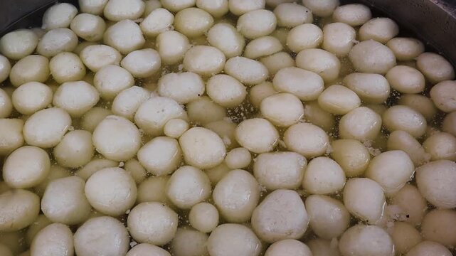 Traditional Rasgulla in Sugar Syrup in a sweet shop