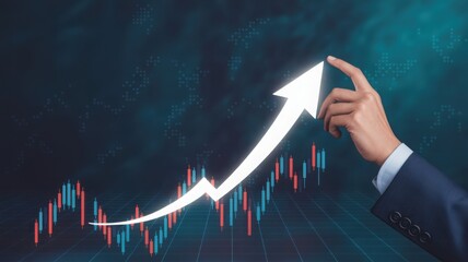 Person's hand drawing an arrow representing economic growth with upward trend graph in the background