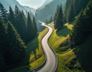 Obraz premium Winding road through lush green mountains forest landscape. Aerial view displays a scenic roadway with trees. Travel adventure concept for vacation and tourism.