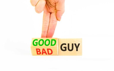 Good or bad guy symbol. Concept words Bad guy to Good guy on beautiful wooden cubes. Beautiful white background. Businessman's hand. Business psychological good or bad guy concept. Copy space.