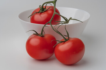 A BUNCH OF TOMATOES IN A PLATE