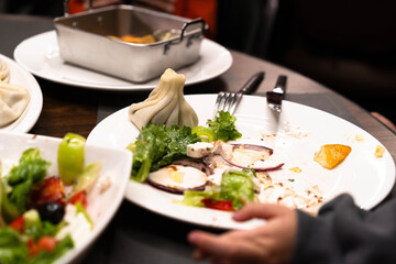 Plates filled with fresh salads and dumplings sit on the table, as family members savor a delightful dinner together, creating cherished moments of joy and warmth.