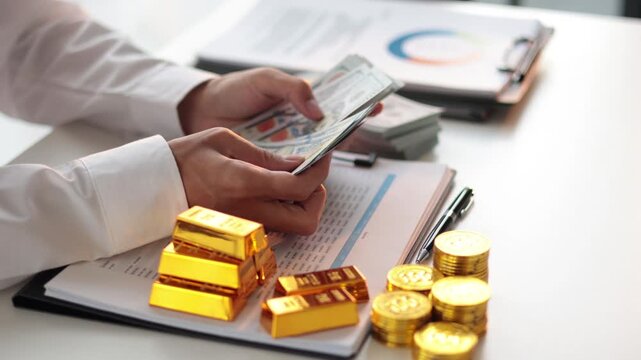 Businessman investing in gold to diversify portfolios hedge against inflation and currency depreciation.
