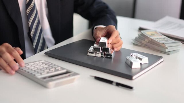 Silver Trading Businessman invest in trading silver, calculating profit price of  buying and selling silver in the market.