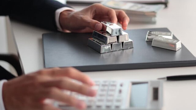 Silver Trading Businessman invest in trading silver, calculating profit price of  buying and selling silver in the market.