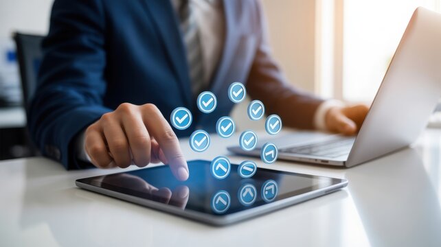 A person interacting with digital tablet in office. Checkmarks floating above the tablet