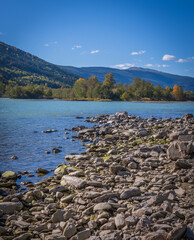 Fototapeta premium Scenic turquoise Lågen River with forested mountains in Norwegian Gudbrandsdalen valley