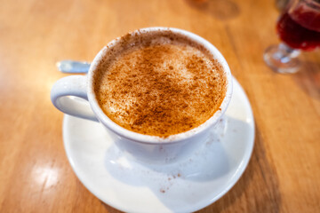 Salep with cinnamon sprinkled. Turkish Salep in cup on table, a popular winter drink in Turkey