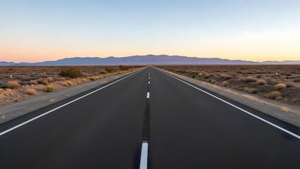 Long straight road stretches through a vast desert landscape towards distant mountains under a clear sky