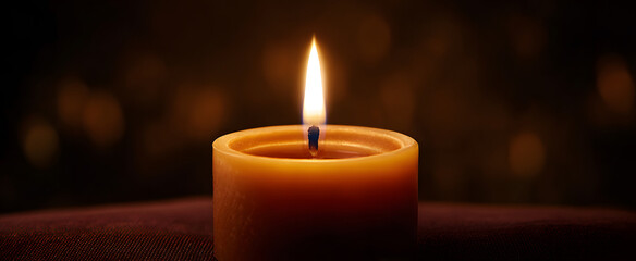The calm light of a candle used for meditation close-up vibe