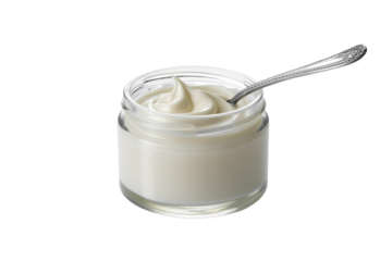 Creamy white yogurt or condiment in a small glass jar with a silver spoon, creating a delicate peak. background removed