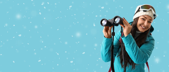 Female guide with binoculars on blue background with snow. Banner for design