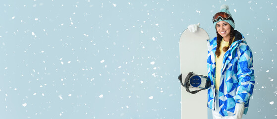Female snowboarder on color background