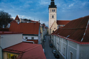 Cobblestone Street Leads to St. Nicholas' Church Spire in Tallinn Old Town
