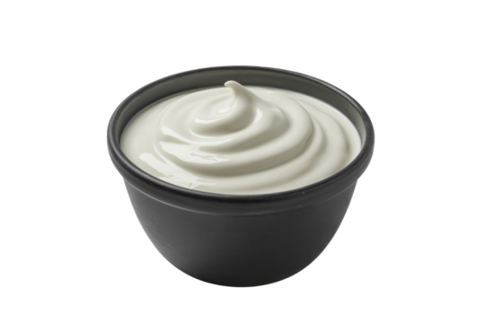 A small black bowl contains a perfectly swirled dollop of thick white cream, resembling sour cream, yogurt, or a creamy sauce. background removed