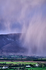 Aerial view of dramatic evening storm clouds at stunning evening in Ireland Co.Mayo, pouring rain beside mountain