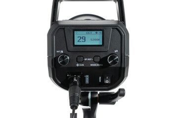 Front view of a studio light control panel with LCD showing 29 and 5200K. Knobs, buttons, power switch, and cable connector isolated on white background.