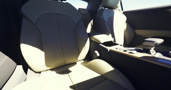 This spacious car interior showcases two comfortable beige seats, designed with ergonomic support. Sunlight highlights the textures, creating a bright and inviting atmosphere.