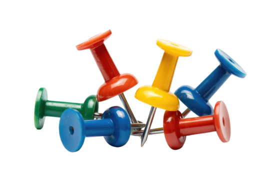 A collection of colorful pushpins in red, yellow, blue, and green, scattered on a background. Essential office supplies for bulletin boards and pinning documents. background removed