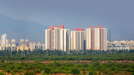Distant view of new construction of tall apartment home buildings in newly developed Navi Mumbai...