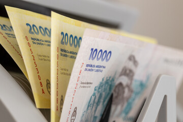 Argentinian pesos in a bill counter. Financial concept. Argentina money. Business background. Close up