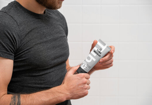 Men Holding Cosmetic Tube PSD Mockup