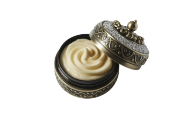 An open, ornate bronze jar with a dazzling, jewel-encrusted lid reveals a creamy, swirled product inside, possibly a luxurious cosmetic or balm. background removed