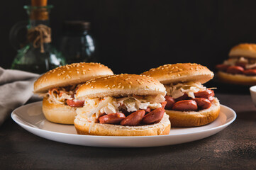 New York-style buns with sausage and sauerkraut on a plate on a table