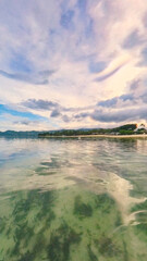 Beautiful transparent water landscape on a point of view just over the surface on a quiet beach sunset cloudscape in Chaweng, Ko Samui, Thailand